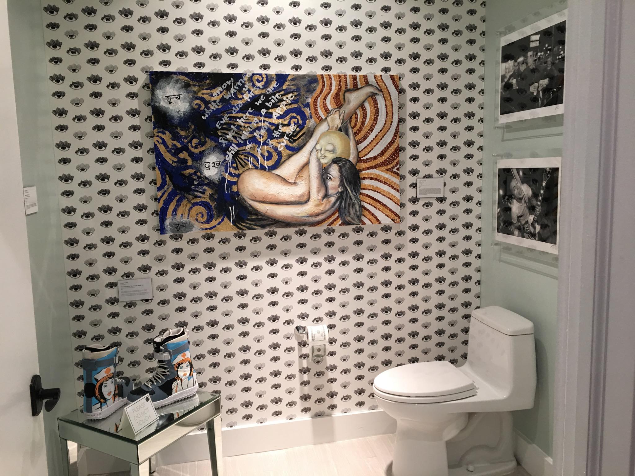 katy-gennaro-painting-eve-figure-installed Katy Gennaro painting Temptations hanging on an eye-patterned wallpapered wall